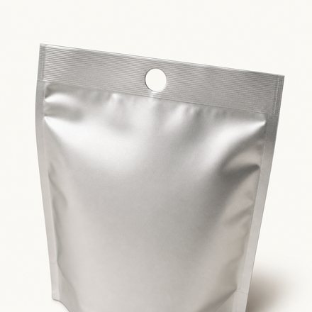 Foil pouch with a punched hang hole near the sealed top edge