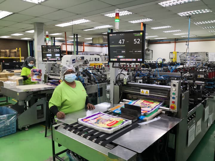 Bag-making line converting laminated film into finished pouches